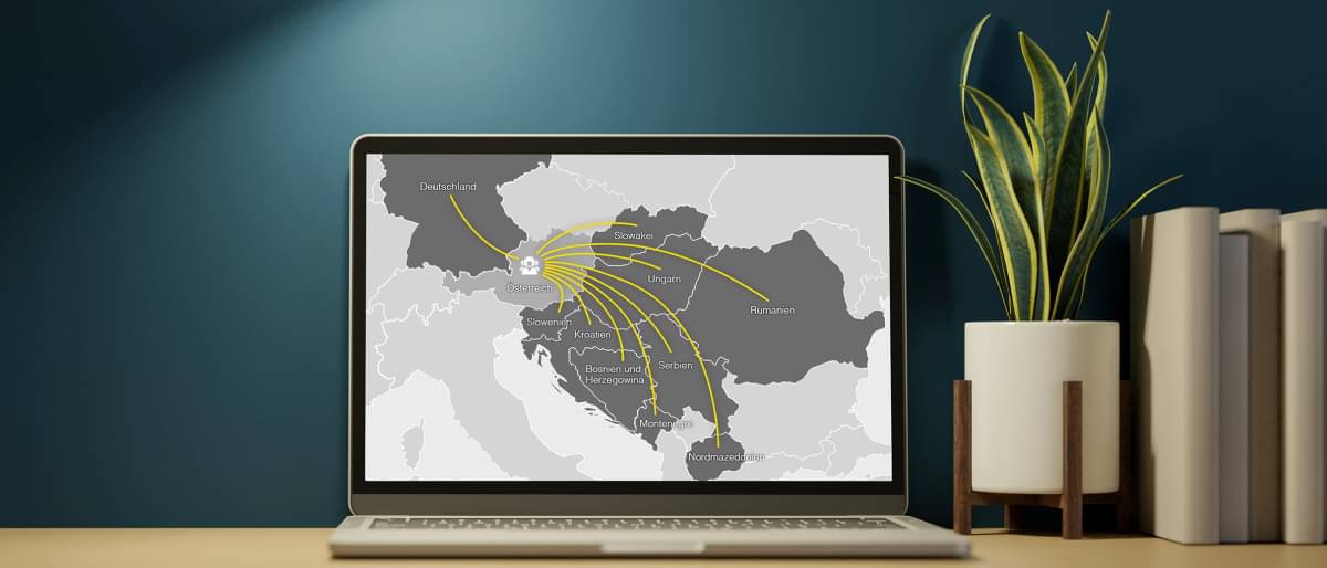 Home office workplace with laptop computer on which a graphic can be seen that offers German companies simplified access to the markets in Croatia, Romania, Serbia, Hungary and Slovakia